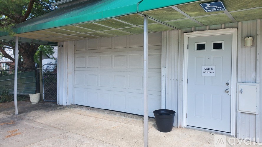 A white garage door with a sign on it.