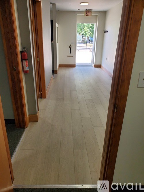 A bathroom with a white counter top and a blue shower curtain.