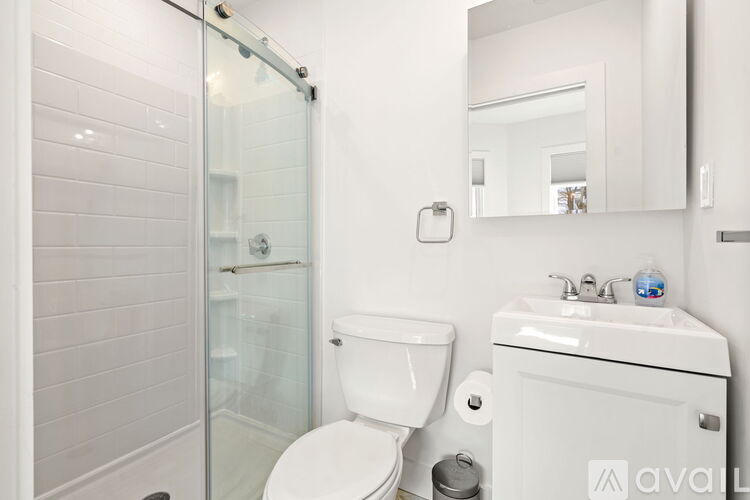 A white toilet sits next to a sink in a bathroom.
