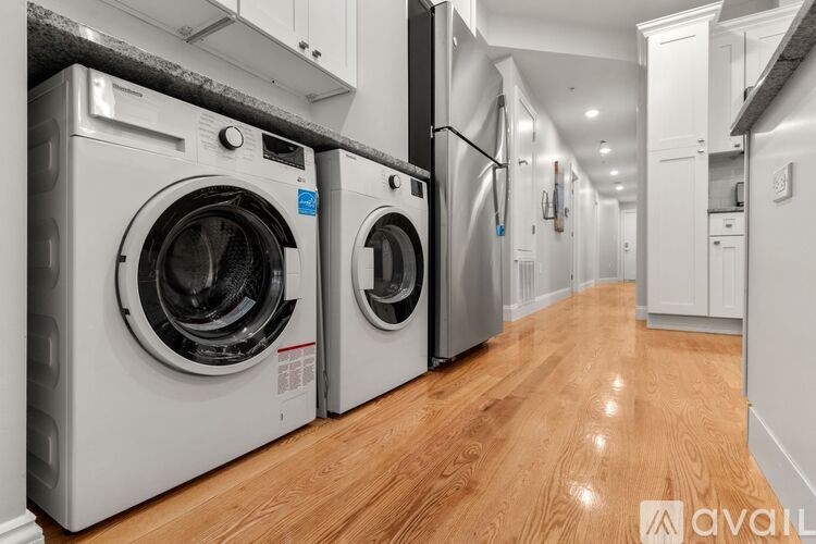 A row of washing machines in a laundry room.