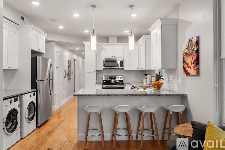A modern kitchen with white cabinets and a central island.