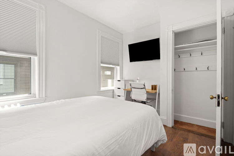 A bedroom with a large bed and a walk-in closet.