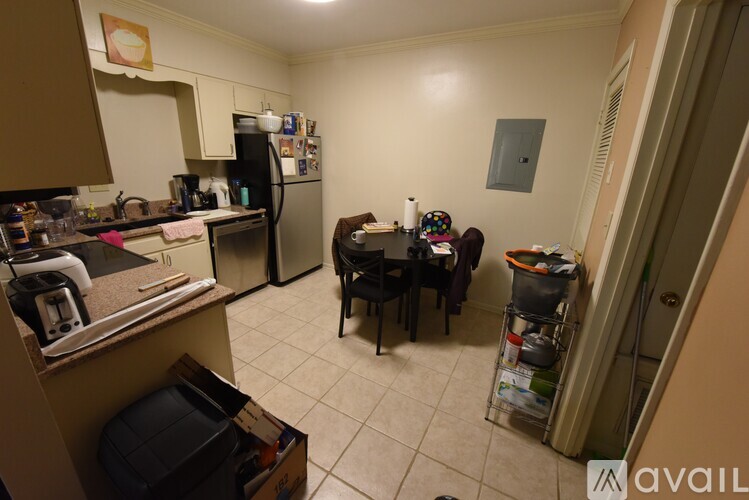 A kitchen with a table and chairs in the middle of the room.