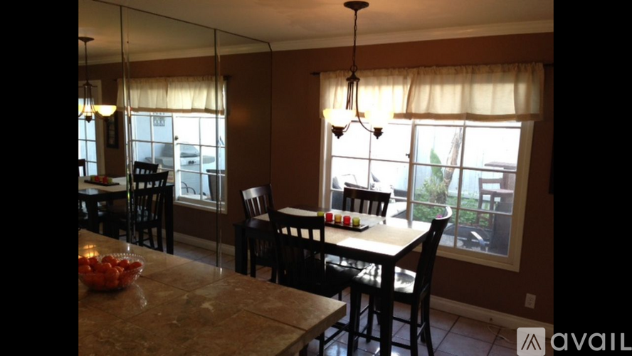 A dining room with a table set for four.