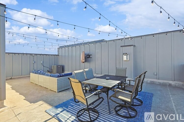 A patio with a table and chairs is set up on a rooftop.