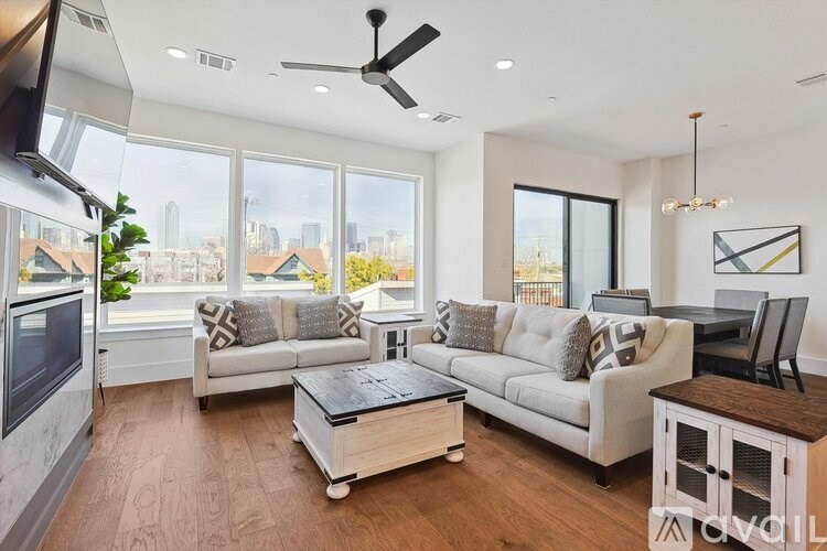 A modern living room with a large window overlooking the city.