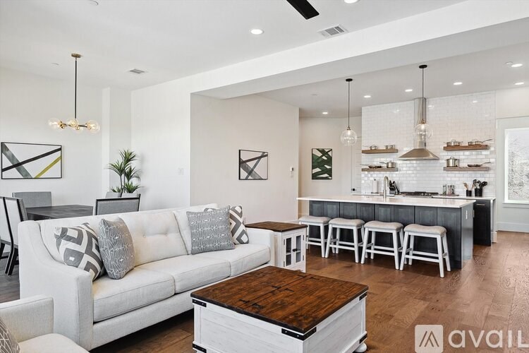A modern living room with a white sofa and a wooden coffee table.