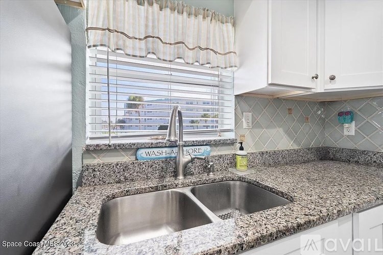 A kitchen with a granite countertop and a sink.