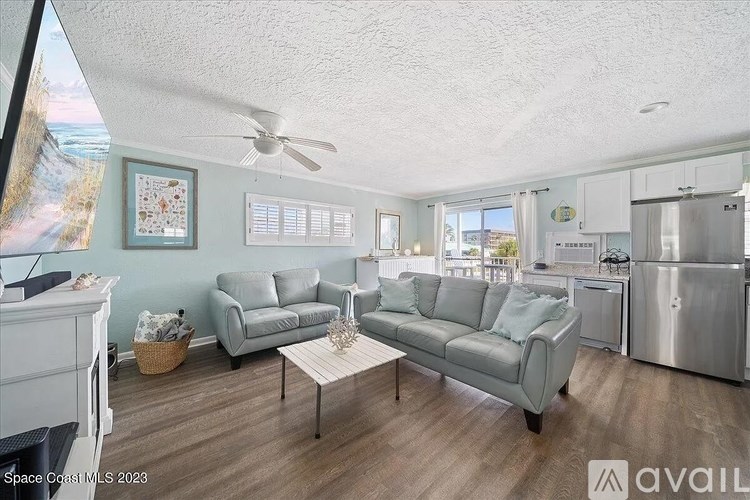 A living room with a grey couch and a coffee table.