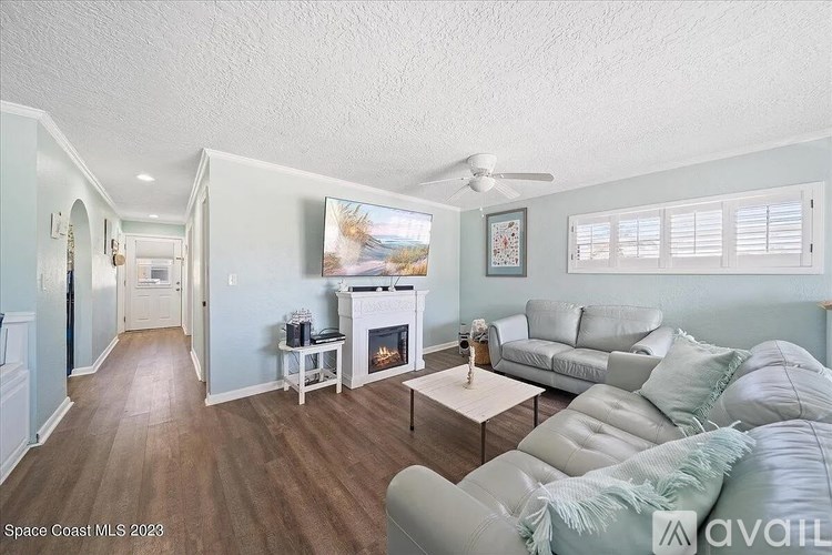A living room with a fireplace and a couch.