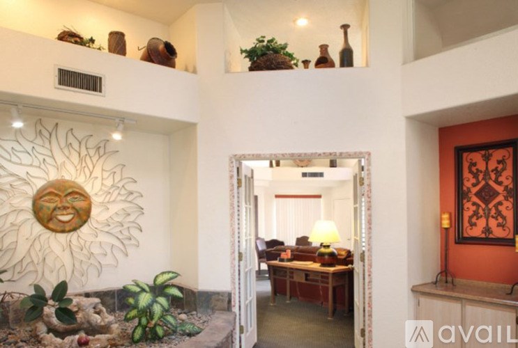 A sun-shaped decoration hangs on a wall in a room.