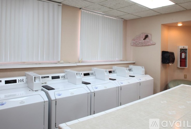 A row of washing machines in a laundromat.