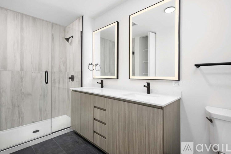 A bathroom with a sink, mirror, and shower.