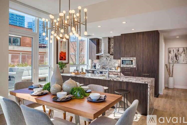 A modern dining room with a wooden table set for a meal.