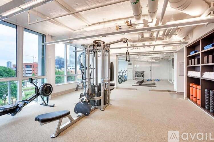 A well-equipped gym with a view of the city.