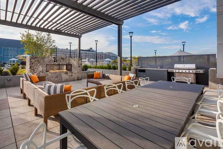 A patio with a table and chairs under a roof.