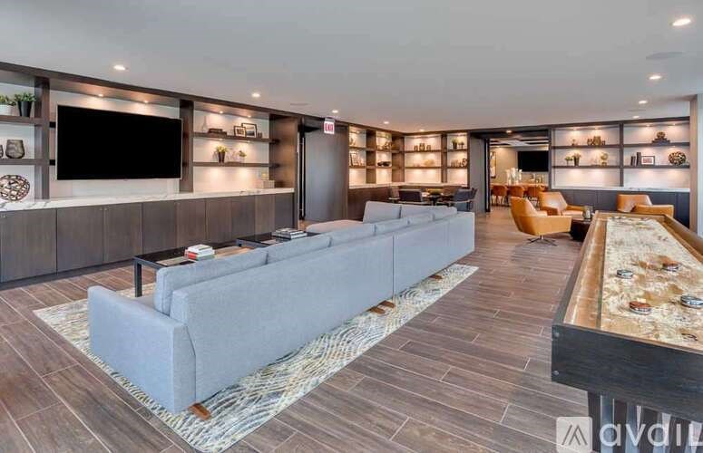 A modern living room with a grey sofa and a wooden coffee table.
