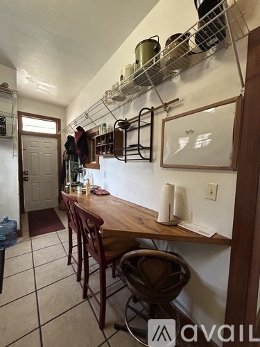 A kitchen with a table and chairs.