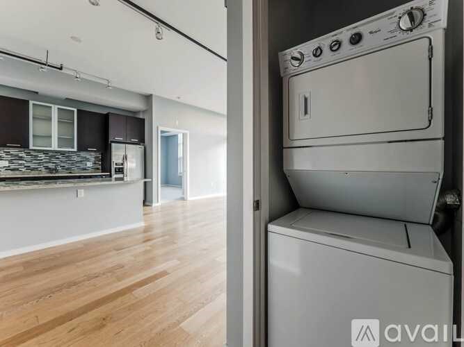 A modern kitchen with a washer and dryer built into the cabinetry.