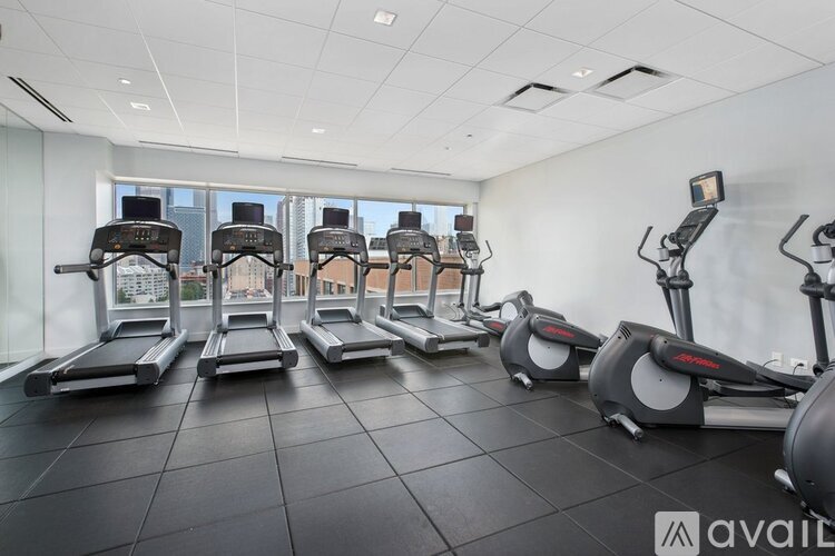 A gym with treadmills and elliptical machines.