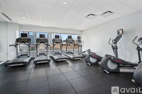 A gym with treadmills and elliptical machines.