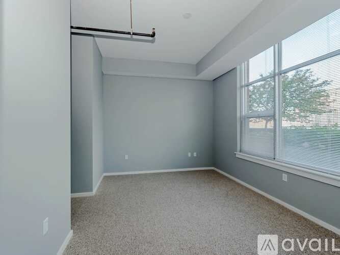 A spacious room with a sliding door and a window.