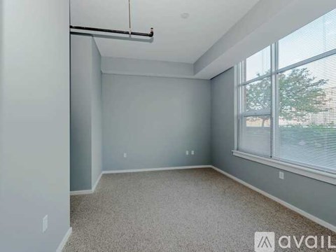 A spacious room with a sliding door and a window.