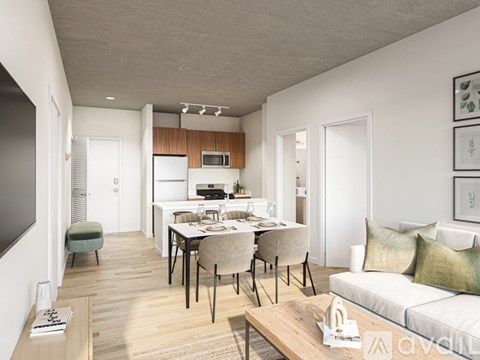 A modern living room with a dining area and kitchen in the background.