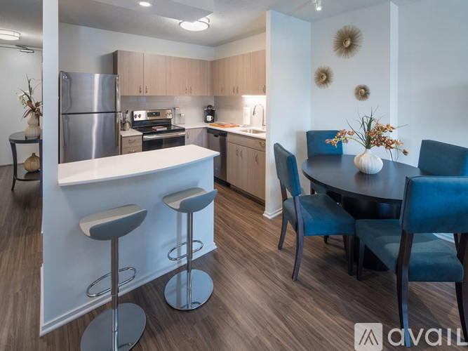 A kitchen with a bar area and a dining table.