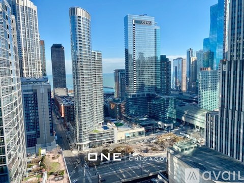 A cityscape with the word "ONE" prominently displayed on a building.