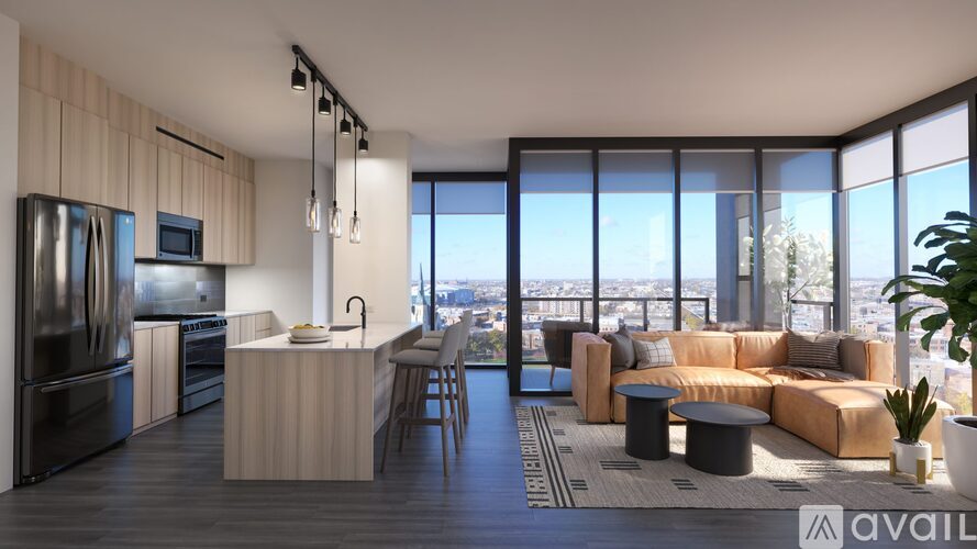 A modern kitchen with a large island and a view of the city.