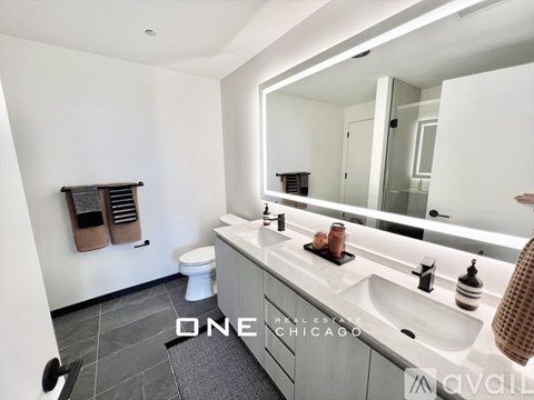 A bathroom with a toilet, sink, mirror and a towel rack.