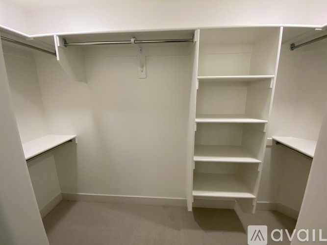 A white closet with shelves and a hanging rail.