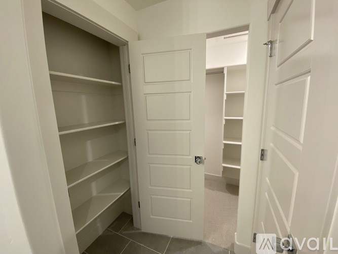A white door with a shelf underneath it.