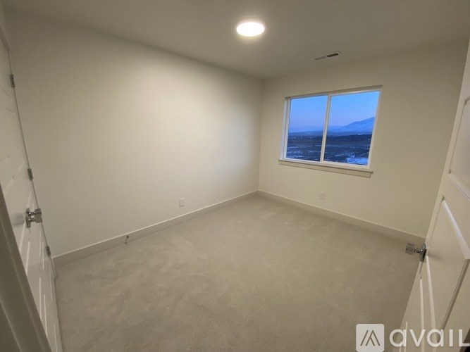 A room with a window overlooking the ocean.