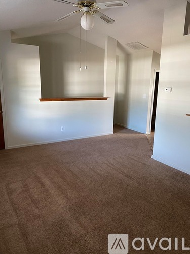 A room with wooden flooring and a ceiling fan.