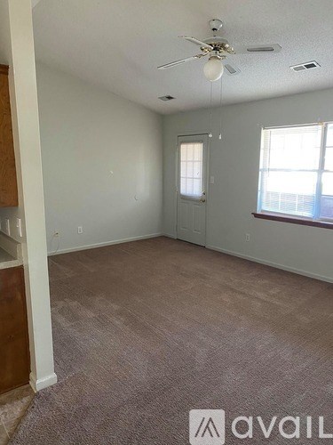 A kitchen with wooden cabinets and a white dishwasher.