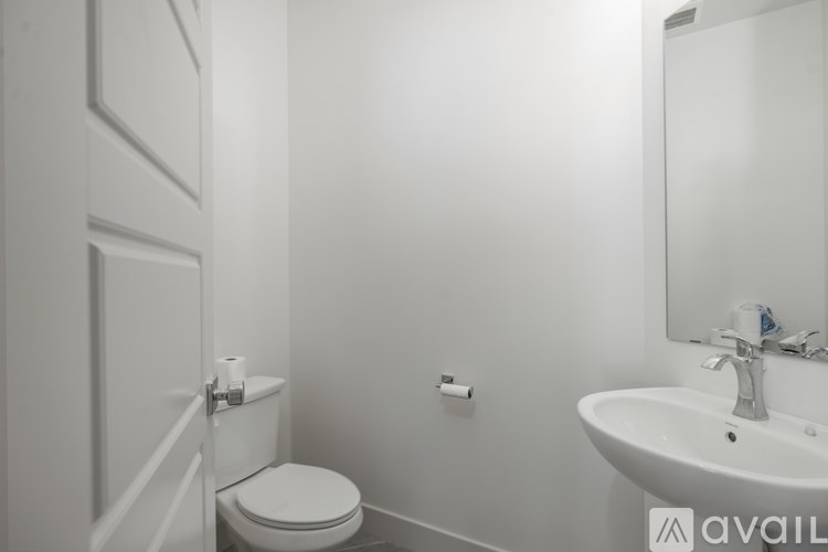 A white toilet sits next to a sink in a bathroom.