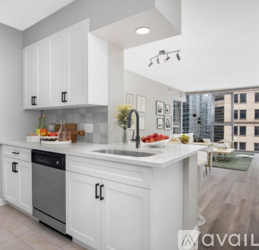 A modern kitchen with white cabinets and a large island.