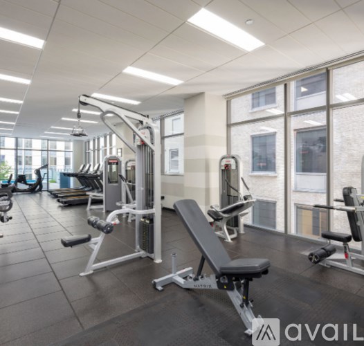 A gym with a variety of equipment including a leg press machine.