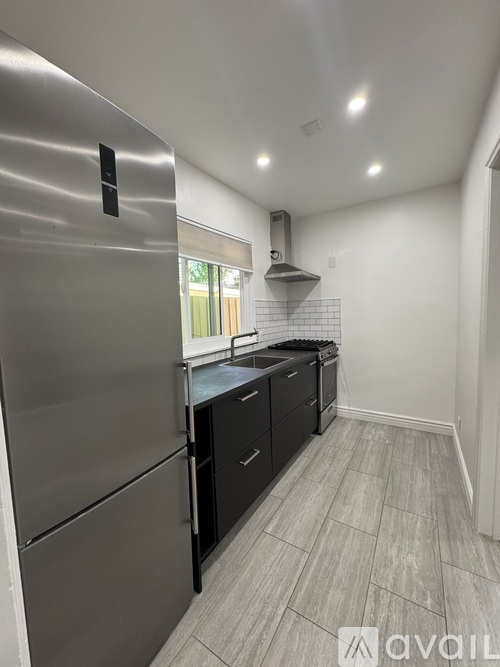 A room with wooden flooring and white walls.