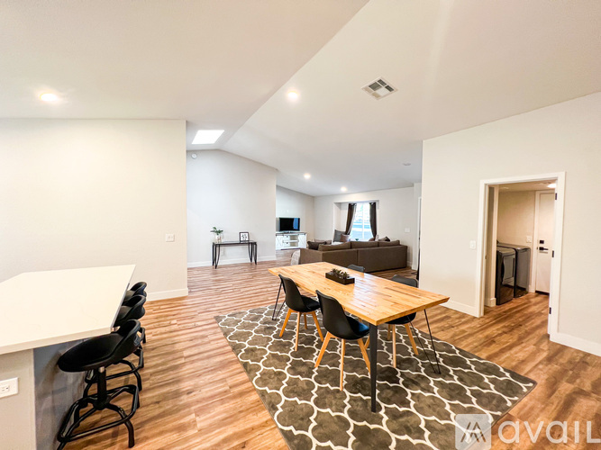 A modern living room with a wooden table and chairs.