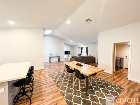 A modern living room with a wooden table and chairs.