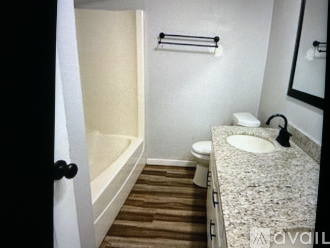 A bathroom with a toilet, sink, and bathtub.