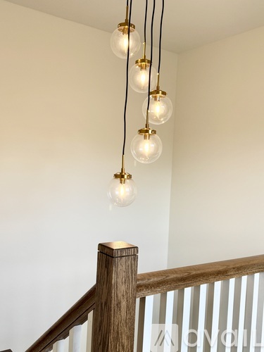 A chandelier with five lights hanging from the ceiling.