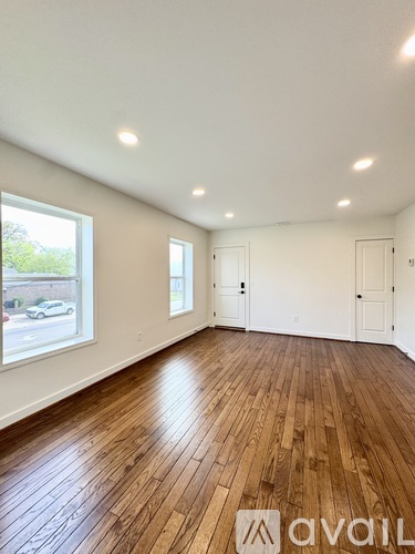 A room with wooden floors and white walls.