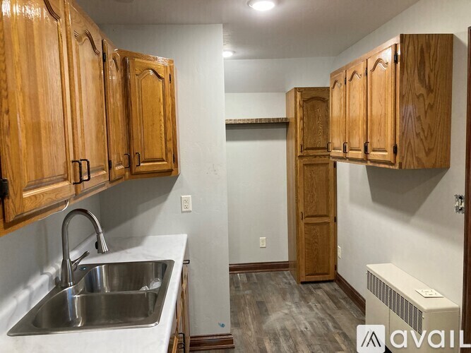 A room with brown tiled flooring and wooden doors.