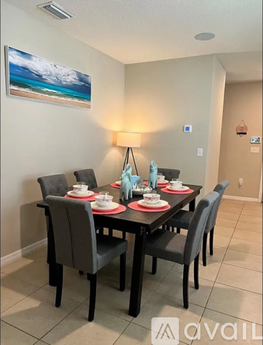 A dining room with a table set for four.