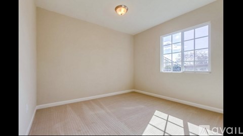 A room with a window and a mat on the floor.
