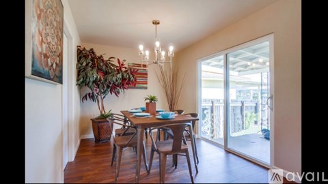 A dining room with a wooden table and chairs.